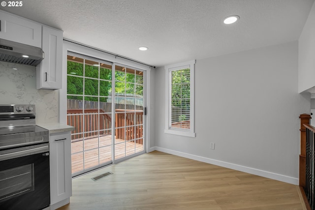 1111 SW Linneman Ave, Gresham, OR 97080 - unfurnished dining area featuring a textured ceiling, light wood-type flooring, and recessed lighting