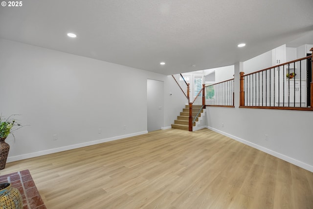 1111 SW Linneman Ave, Gresham, OR 97080 - unfurnished living room featuring light wood-style floors, stairs, and recessed lighting