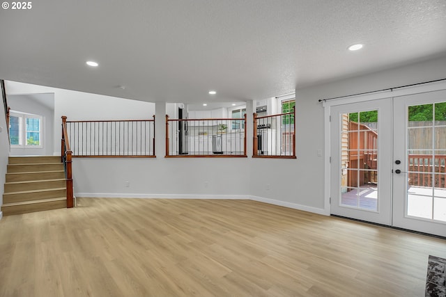 1111 SW Linneman Ave, Gresham, OR 97080 - spare room with light wood-style flooring, healthy amount of natural light, french doors, recessed lighting, and a textured ceiling