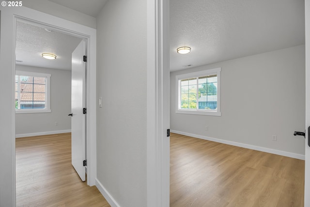 1111 SW Linneman Ave, Gresham, OR 97080 - hallway featuring a textured ceiling and light wood-style flooring