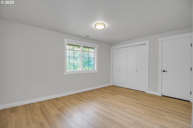 1111 SW Linneman Ave, Gresham, OR 97080 - unfurnished bedroom with light wood-style flooring, a textured ceiling, and a closet