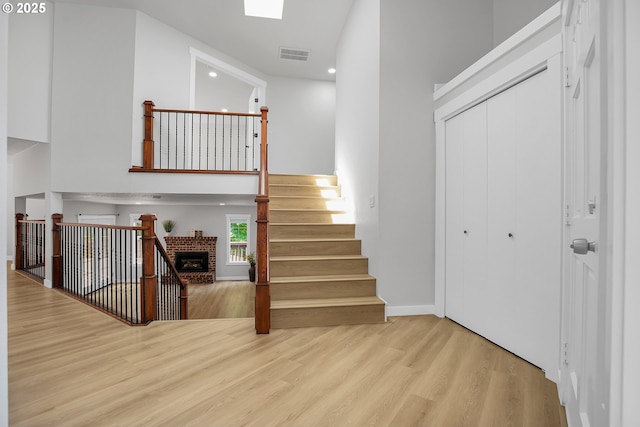 1111 SW Linneman Ave, Gresham, OR 97080 - stairs with wood finished floors, a high ceiling, recessed lighting, and a fireplace