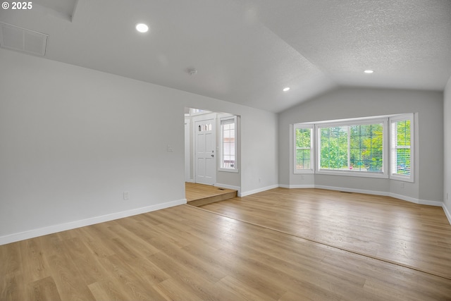 1111 SW Linneman Ave, Gresham, OR 97080 - empty room featuring vaulted ceiling, light wood-type flooring, a textured ceiling, and recessed lighting