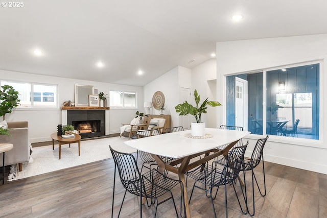 dining space with wood-type flooring and lofted ceiling