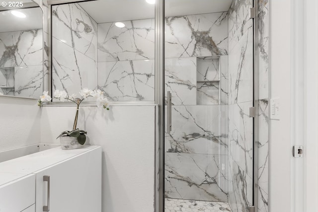 bathroom featuring a shower with shower door