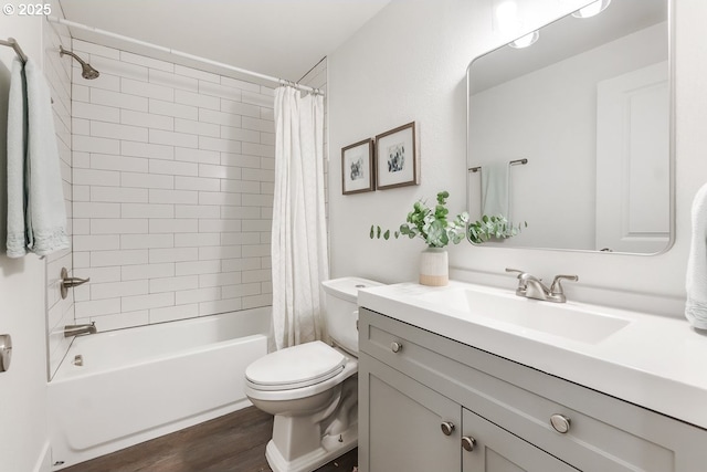 full bathroom featuring hardwood / wood-style floors, vanity, shower / tub combo, and toilet