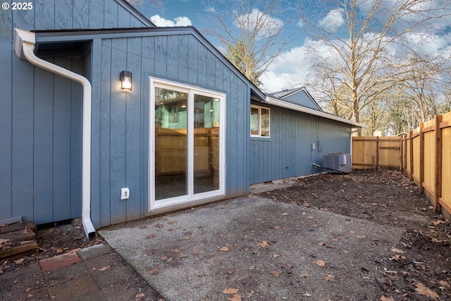 view of property exterior with a patio and central AC