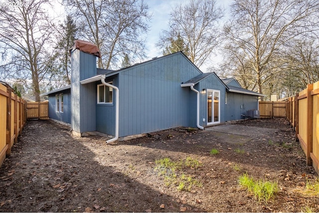 back of house featuring central air condition unit