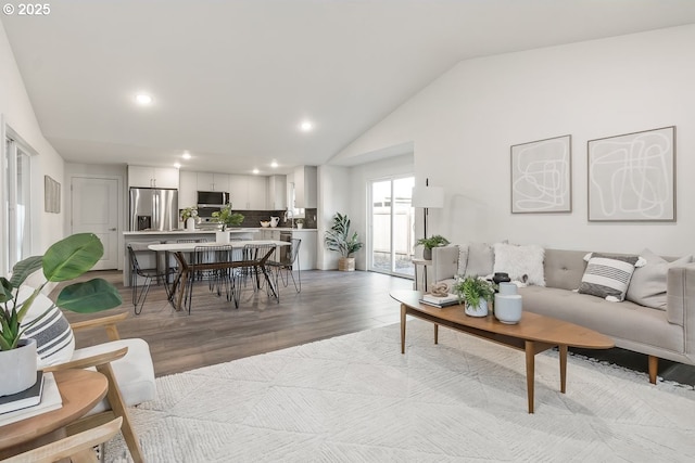 living room with lofted ceiling and light hardwood / wood-style flooring