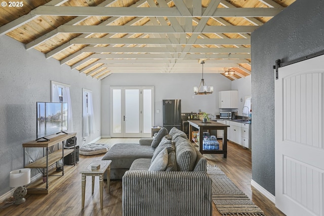 11868 N Jantzen Dr, Portland, OR 97217 - living room featuring a barn door, dark wood-style flooring, a textured wall, wooden ceiling, and baseboards