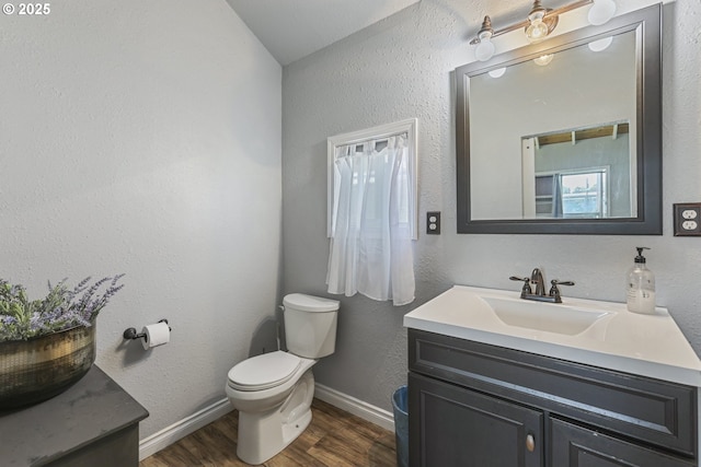 11868 N Jantzen Dr, Portland, OR 97217 - half bath with vanity, toilet, wood finished floors, and baseboards