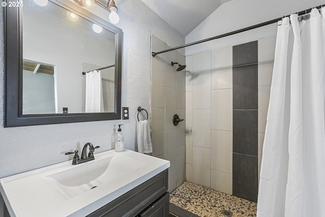 11868 N Jantzen Dr, Portland, OR 97217 - bathroom featuring a textured wall, lofted ceiling, vanity, and a tile shower