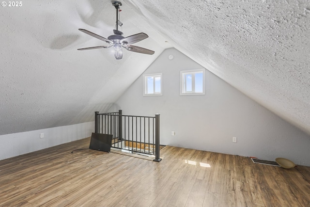11868 N Jantzen Dr, Portland, OR 97217 - additional living space featuring a textured ceiling, a ceiling fan, vaulted ceiling, and wood finished floors