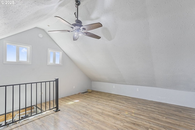 11868 N Jantzen Dr, Portland, OR 97217 - bonus room featuring a textured ceiling, wood finished floors, lofted ceiling, and a ceiling fan