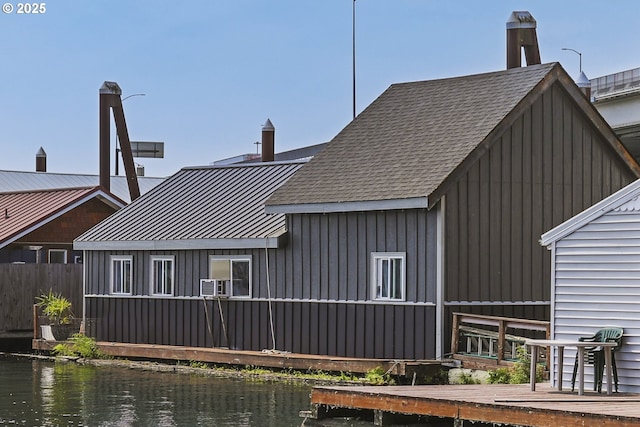 11868 N Jantzen Dr, Portland, OR 97217 - back of property featuring a water view, board and batten siding, and cooling unit