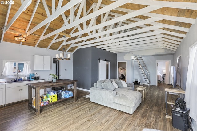 11868 N Jantzen Dr, Portland, OR 97217 - living area with a barn door, wood finished floors, beamed ceiling, and high vaulted ceiling