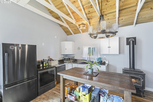 11868 N Jantzen Dr, Portland, OR 97217 - kitchen with appliances with stainless steel finishes, wood ceiling, a chandelier, wood finished floors, and white cabinetry