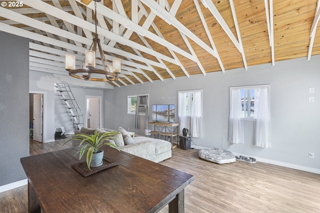 11868 N Jantzen Dr, Portland, OR 97217 - dining area featuring a chandelier, wood finished floors, baseboards, wood ceiling with exposed beams, and high vaulted ceiling