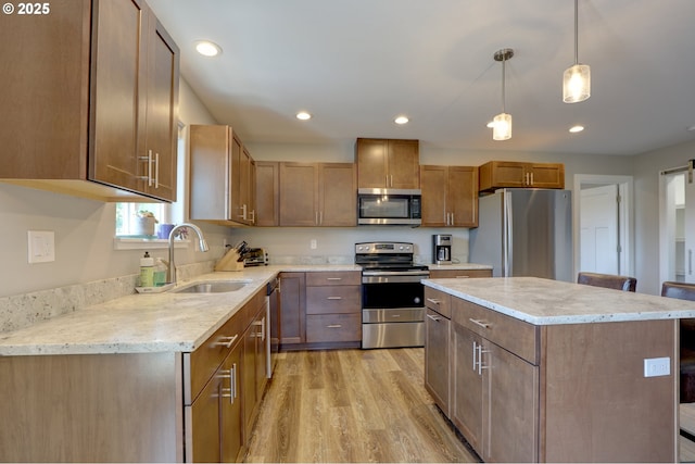 1637 E 21st St, The Dalles, OR 97058 - kitchen featuring stainless steel appliances, a sink, light wood-type flooring, a kitchen island, and recessed lighting