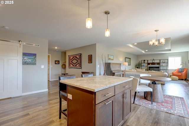 1637 E 21st St, The Dalles, OR 97058 - kitchen featuring wood finished floors, a center island, a kitchen breakfast bar, open floor plan, and recessed lighting