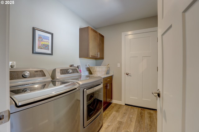 1637 E 21st St, The Dalles, OR 97058 - washroom with washer and clothes dryer, light wood-style flooring, and cabinet space