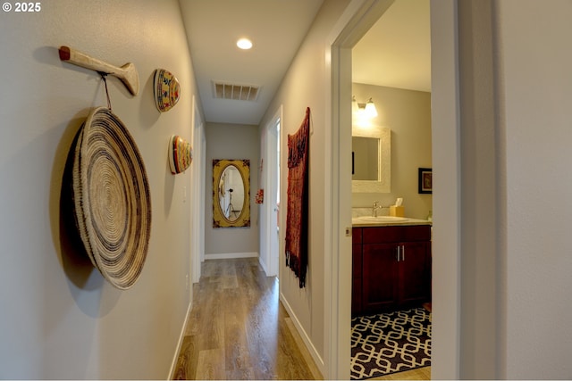1637 E 21st St, The Dalles, OR 97058 - corridor featuring light wood-style flooring, a sink, and baseboards