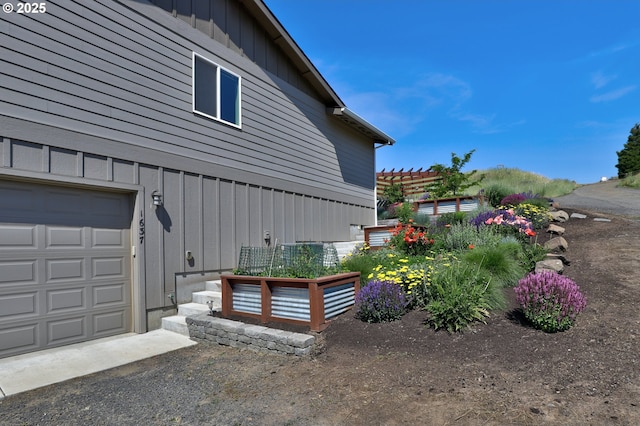 1637 E 21st St, The Dalles, OR 97058 - view of side of home featuring board and batten siding and a garage