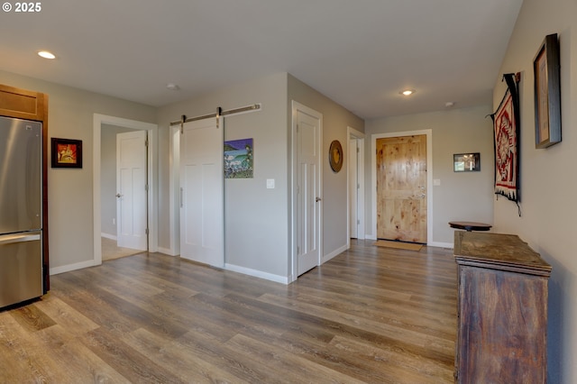 1637 E 21st St, The Dalles, OR 97058 - foyer entrance featuring a barn door, wood finished floors, recessed lighting, and baseboards