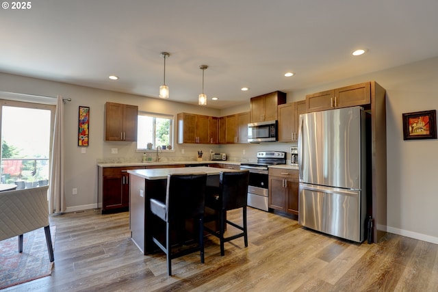 1637 E 21st St, The Dalles, OR 97058 - kitchen with appliances with stainless steel finishes, light countertops, recessed lighting, baseboards, and light wood-type flooring