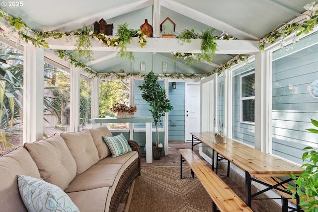 sunroom featuring lofted ceiling