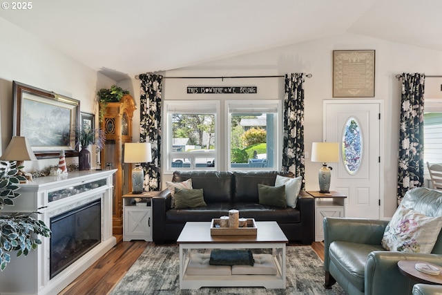 living room with lofted ceiling and wood finished floors
