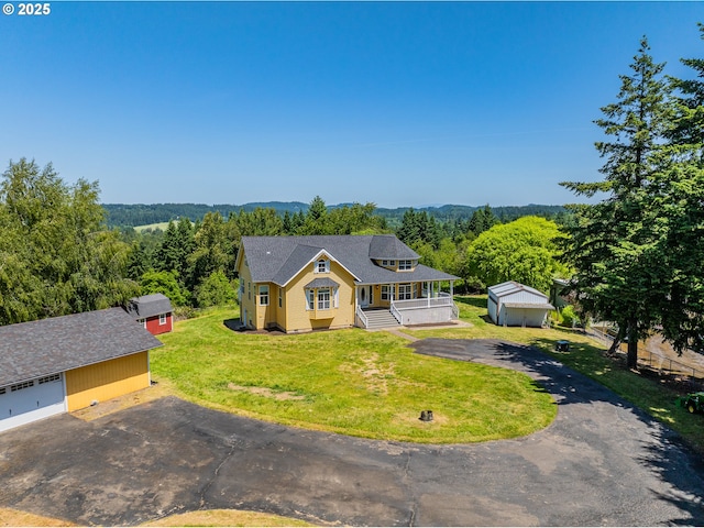 18266 S Holly Ln, Oregon City, OR 97045 - view of front facade featuring an outdoor structure, a porch, a front yard, and a view of trees