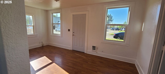 323 Academy St, Salem, OR 97301 - doorway with dark wood-style flooring and baseboards