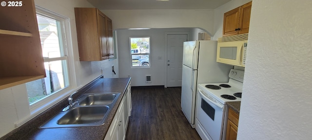 323 Academy St, Salem, OR 97301 - kitchen featuring white appliances, brown cabinets, a sink, dark countertops, and dark wood finished floors