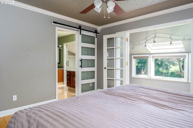 11782 SE 108th Ave, Happy Valley, OR 97086 - bedroom with ornamental molding, a barn door, ensuite bathroom, and a textured ceiling