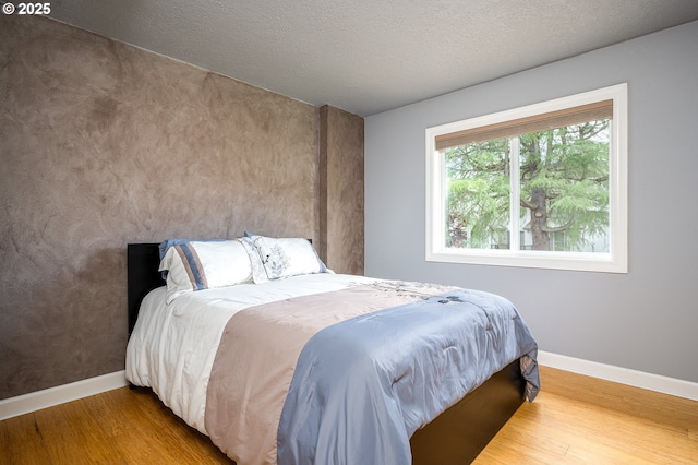 11782 SE 108th Ave, Happy Valley, OR 97086 - bedroom featuring wood finished floors and a textured ceiling