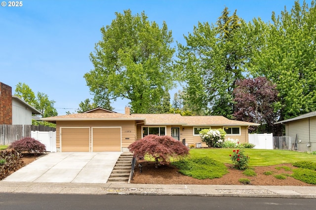 11975 SW Blakeney St, Beaverton, OR 97008 - single story home with a garage, concrete driveway, and a chimney