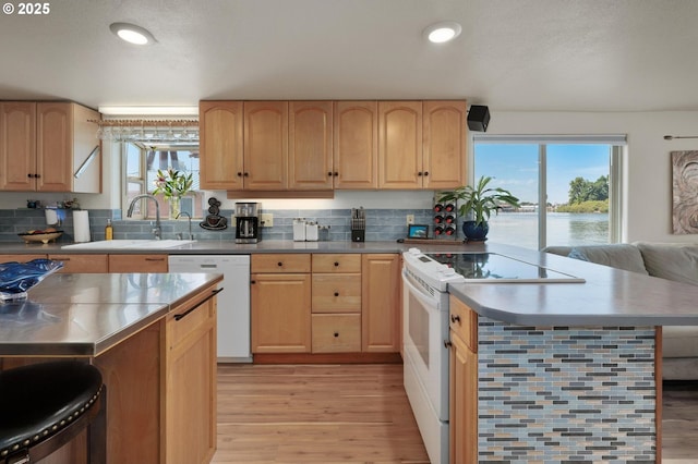 429 N Bridgeton Rd # 15, Portland, OR 97217 - kitchen with white appliances, light brown cabinetry, light wood-style floors, and recessed lighting