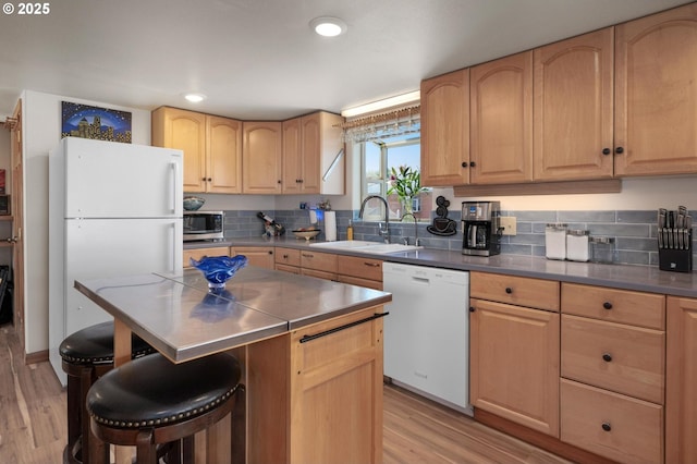 429 N Bridgeton Rd # 15, Portland, OR 97217 - kitchen with white appliances, light brown cabinetry, a kitchen bar, light wood-style flooring, and recessed lighting