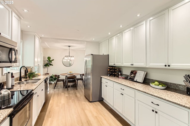 4080 SW 196th Ave, Beaverton, OR 97078 - kitchen with appliances with stainless steel finishes, white cabinets, light wood finished floors, recessed lighting, and light stone counters