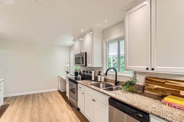 4080 SW 196th Ave, Beaverton, OR 97078 - kitchen featuring appliances with stainless steel finishes, light wood-style flooring, white cabinetry, light stone countertops, and recessed lighting