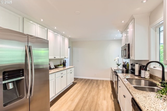 4080 SW 196th Ave, Beaverton, OR 97078 - kitchen with stainless steel appliances, white cabinets, light wood-style floors, recessed lighting, and light stone countertops