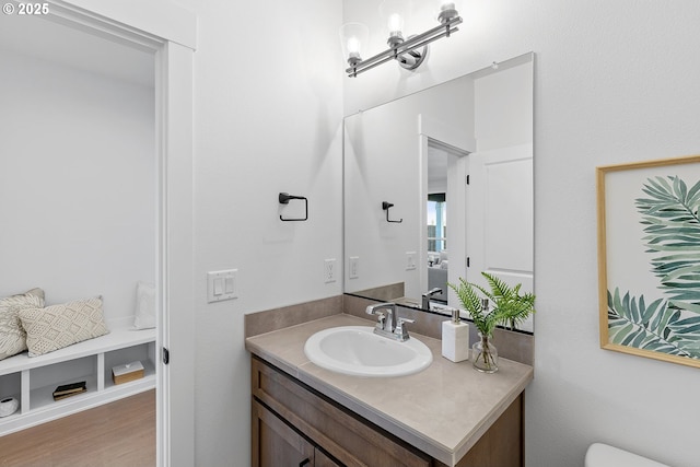 bathroom featuring vanity, wood-type flooring, and an inviting chandelier