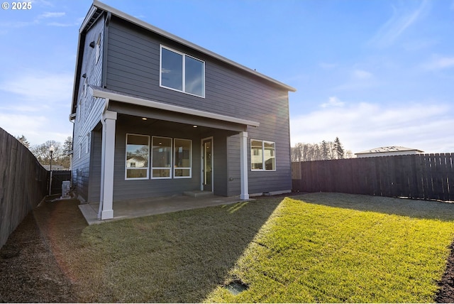 back of house featuring a yard and a patio