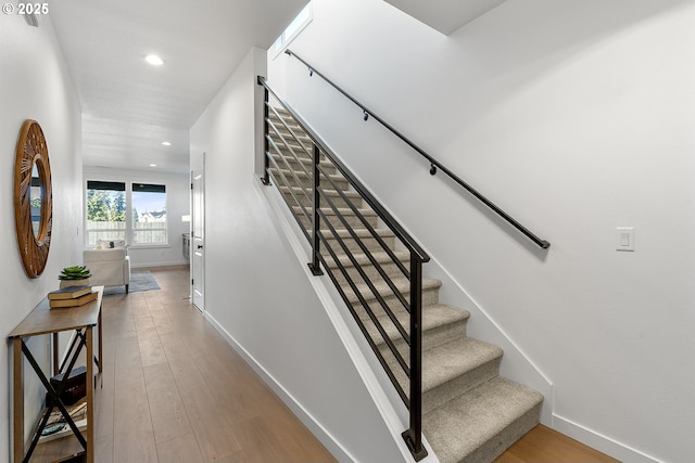 stairway featuring hardwood / wood-style floors