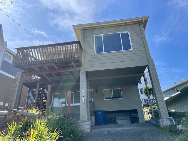 3244 NW Oar Dr, Lincoln City, OR 97367 - rear view of house with a deck and stairs