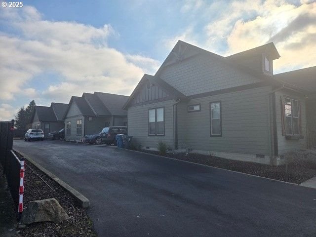 exterior space with crawl space and board and batten siding