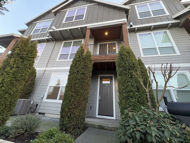 view of front of house featuring a balcony and cooling unit