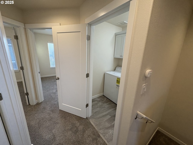 hall featuring carpet flooring and washer / dryer