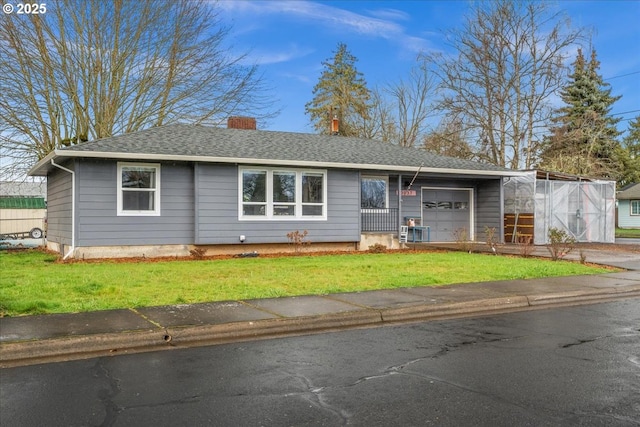 ranch-style home featuring a front lawn, a garage, roof with shingles, and a chimney